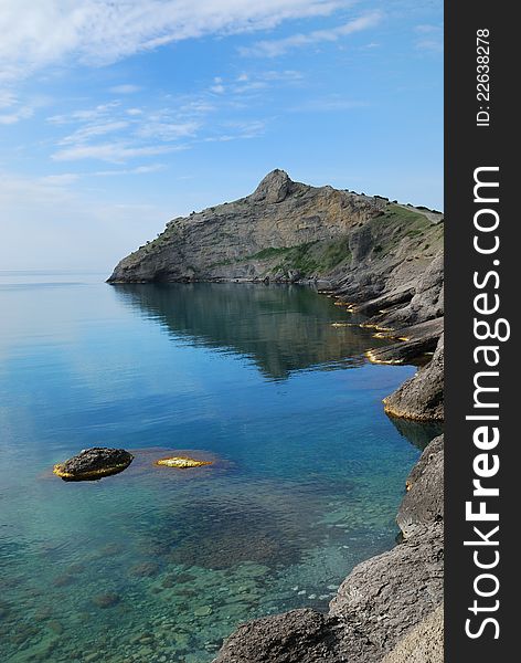 The pointed cape juts far into the Black Sea. This headland together with cape Hoba-Kaya have formed the Blue bay of Novij Svet. The pointed cape juts far into the Black Sea. This headland together with cape Hoba-Kaya have formed the Blue bay of Novij Svet.