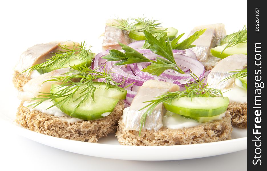 Sandwiches with herring, cucumber and dill