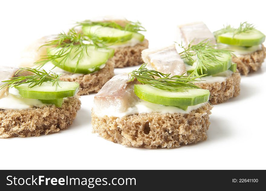 Sandwiches with herring, cucumber and dill