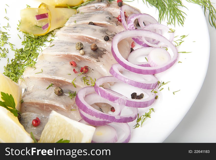 Portion of a herring with an onions and fennel. Portion of a herring with an onions and fennel