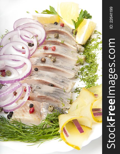 Portion of a herring with an onions and fennel. Portion of a herring with an onions and fennel