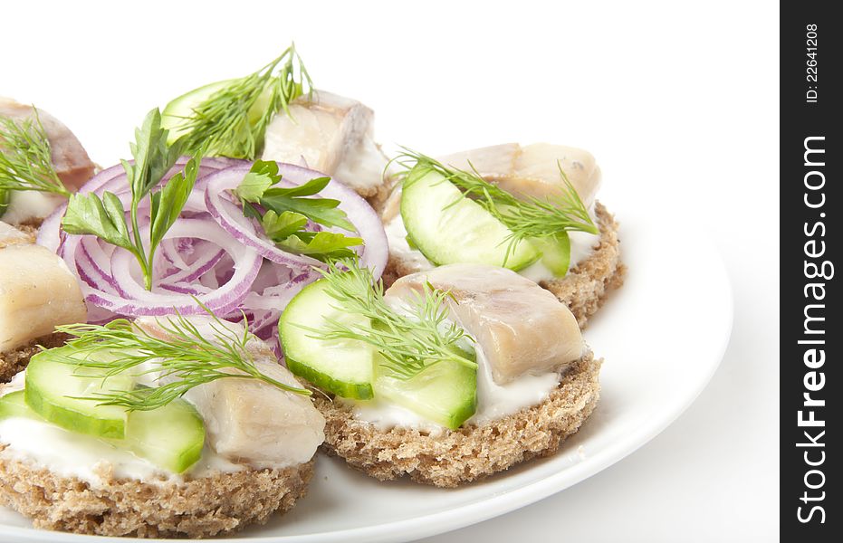 Sandwiches with herring, cucumber and dill