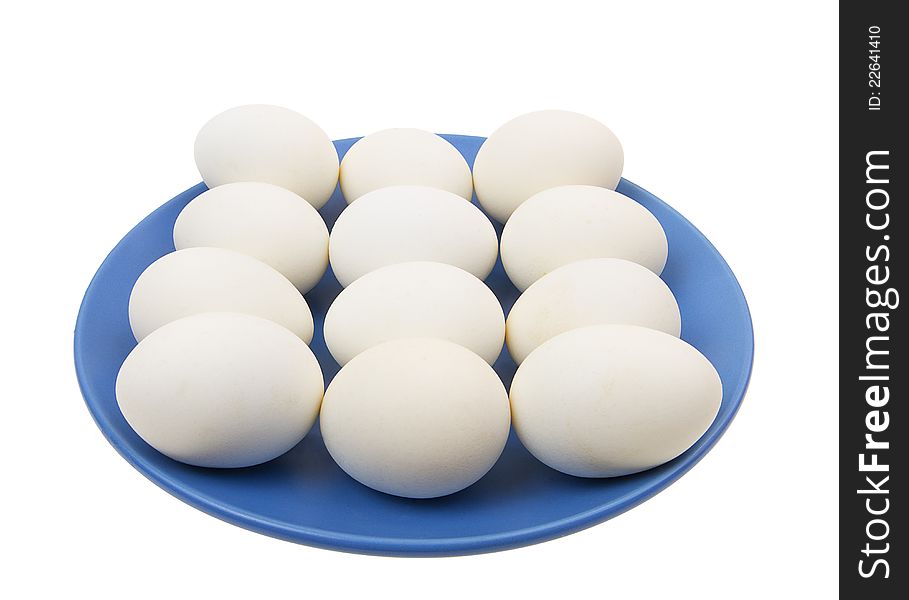 Eggs on the blue plate isolated on white background