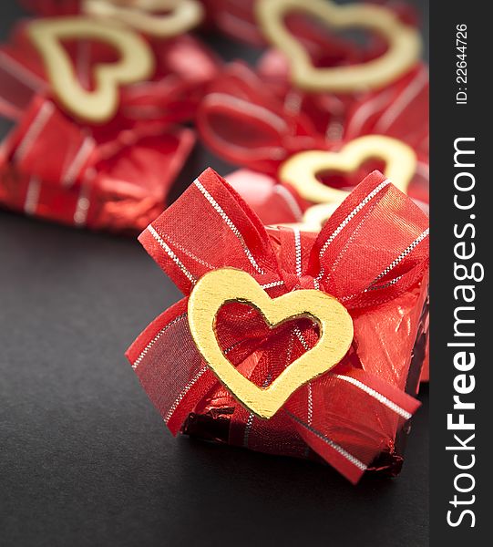 Valentines chocolate in red on dark background. Valentines chocolate in red on dark background