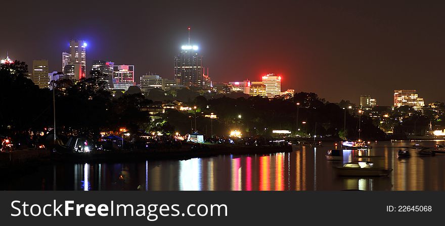 Panoramic view to the skyline of North Sydney by night - with lights reflections on the Parramatta River. Panoramic view to the skyline of North Sydney by night - with lights reflections on the Parramatta River