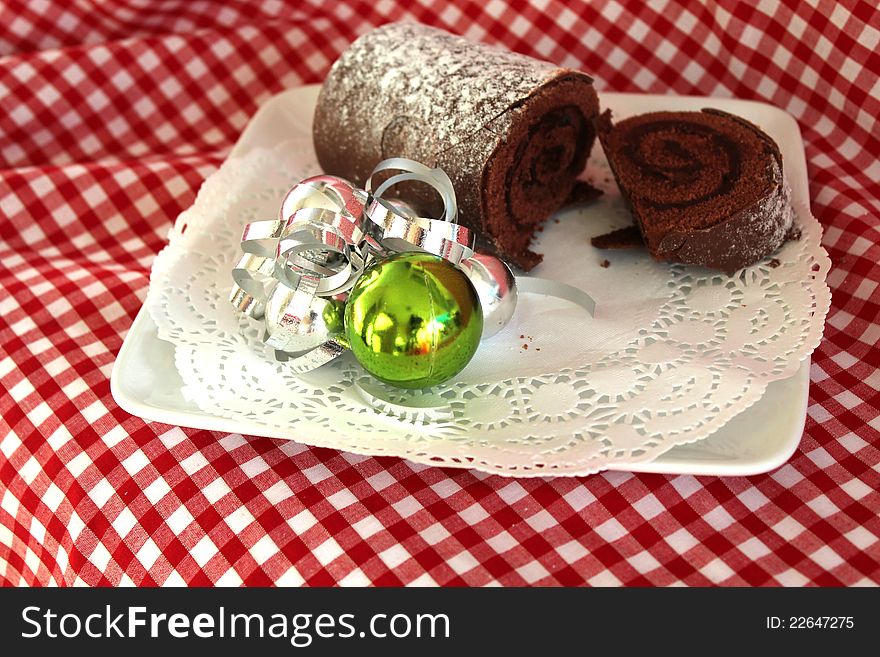 This photo shows a plated Chocolate Yule Log with Decoration. This photo shows a plated Chocolate Yule Log with Decoration