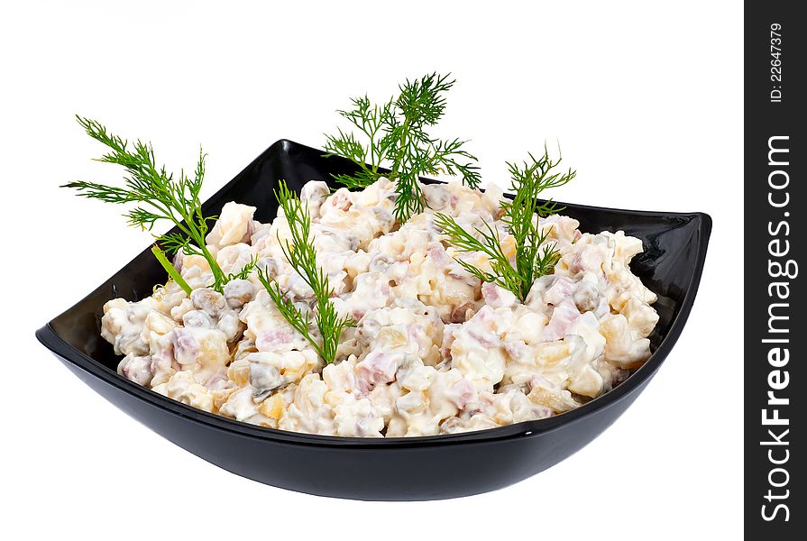 Russian salad in a black plate on a white background