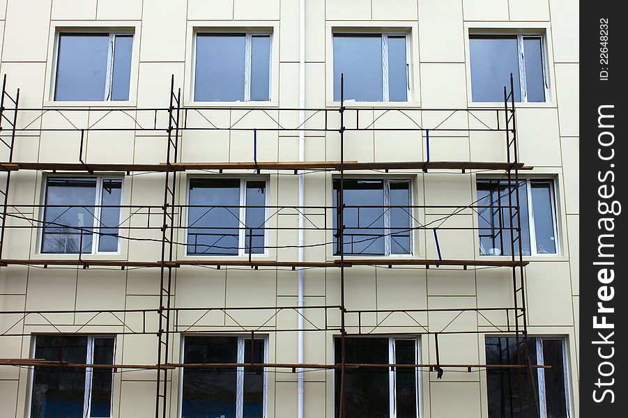 Scaffold against the wall and some windows