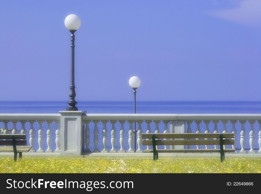 Waterfront with street lamps and seats