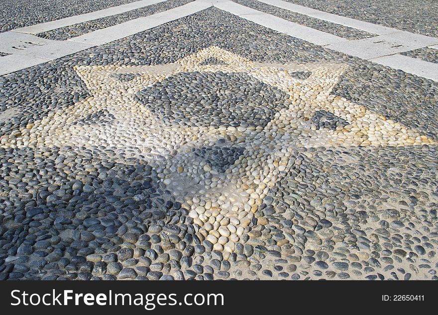 Star shaped symbol on the pavement in front of the church - Vigevano Italy. Star shaped symbol on the pavement in front of the church - Vigevano Italy