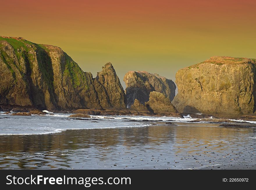 Sunset over the rocks, along the beach