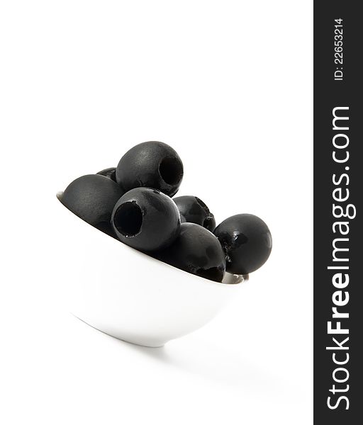 Black olives in a bowl  on white