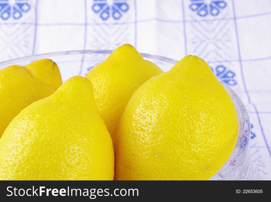 Lemon Fruits inside a glass on a blue white tablecloth, Yellow, Citrus