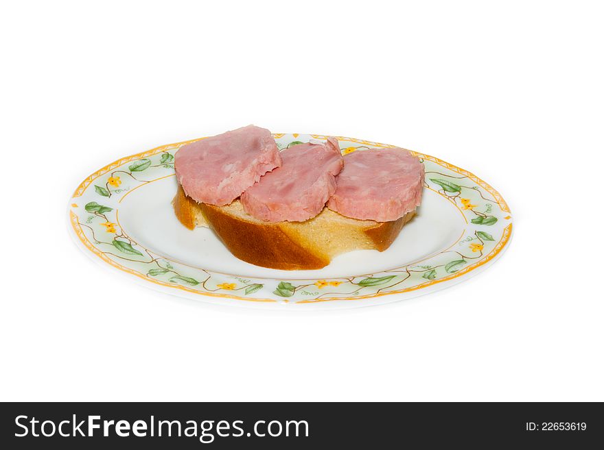 Club sandwiches with ham and cheese on a plate close-up