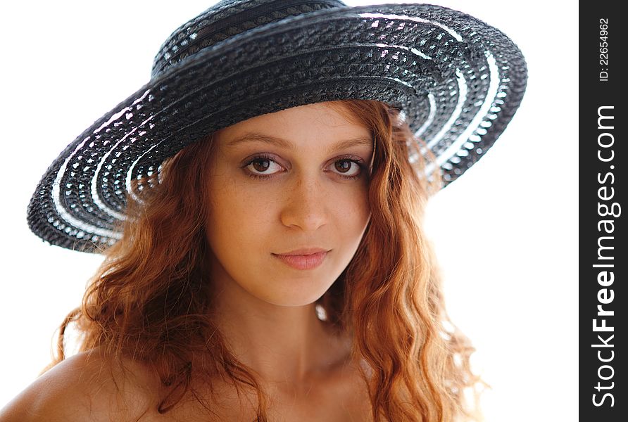 A portrait of a gorgeous young woman in a black hat. A portrait of a gorgeous young woman in a black hat