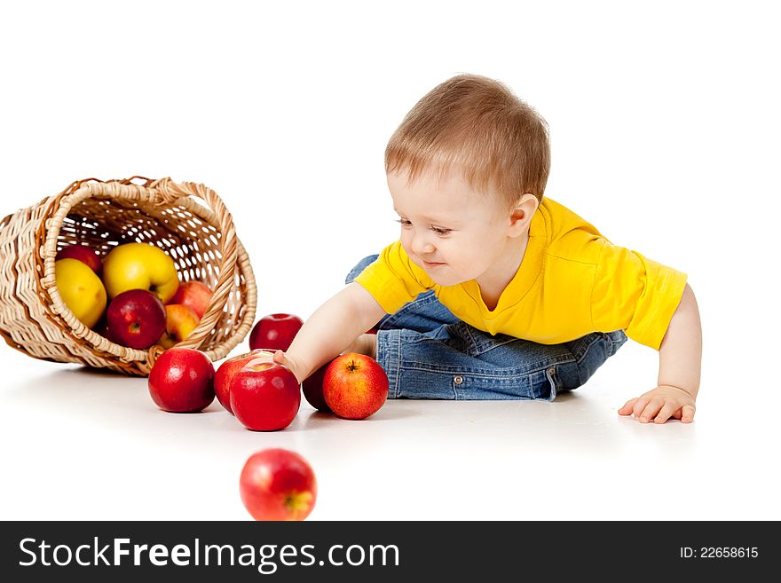 Funny child with basket filling red apples