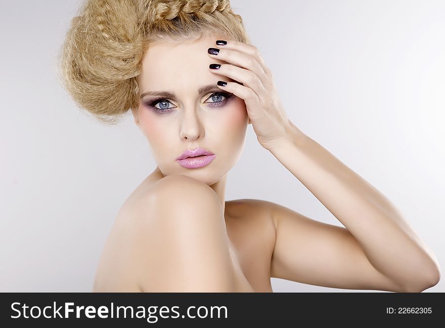 Young pretty woman with beautiful blond hairs and multicolor makeup  on white background