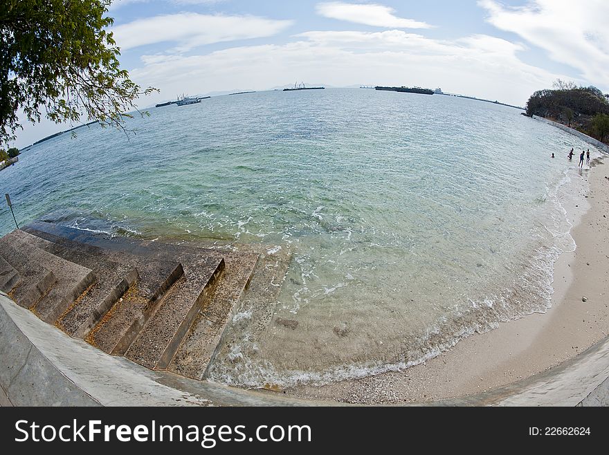 Cement ladder to the beach with wide angle view
