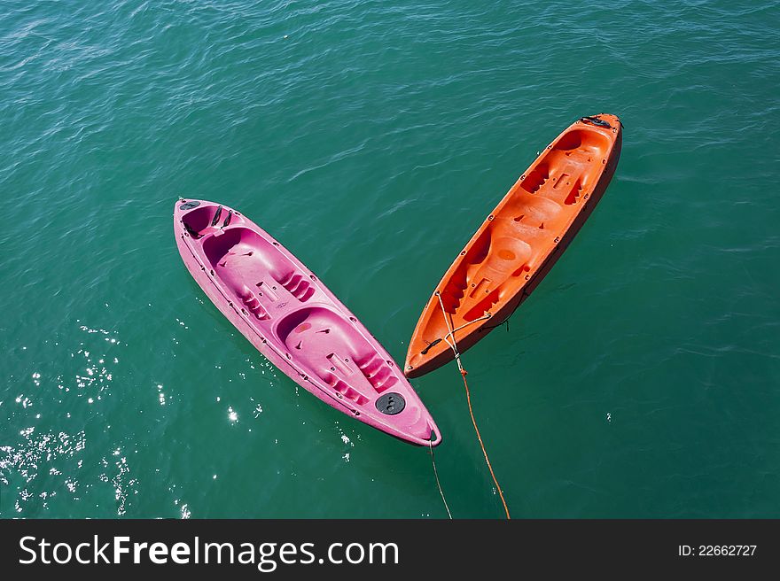 Two Colorful Kayaks In The Sea