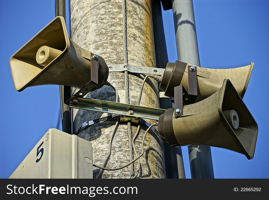 Three public loudspeakers mounted on concrete pillar. Three public loudspeakers mounted on concrete pillar