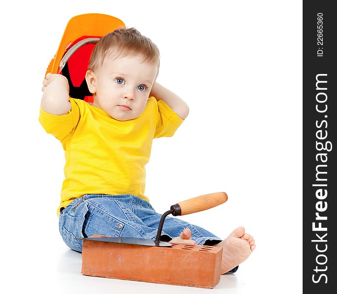 Adorable child with hard hat and construction tools