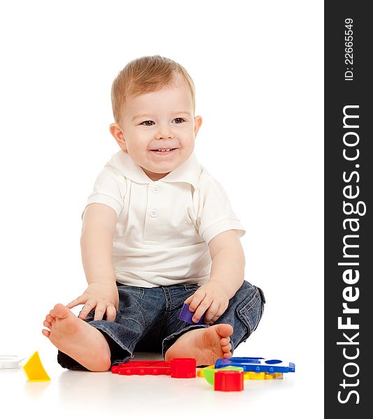 Cute little child is playing with toys while sitting on floor. Cute little child is playing with toys while sitting on floor