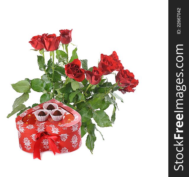 Bunch of red roses and heart-shaped gift with chocolate for St.Valentine's Day. Bunch of red roses and heart-shaped gift with chocolate for St.Valentine's Day