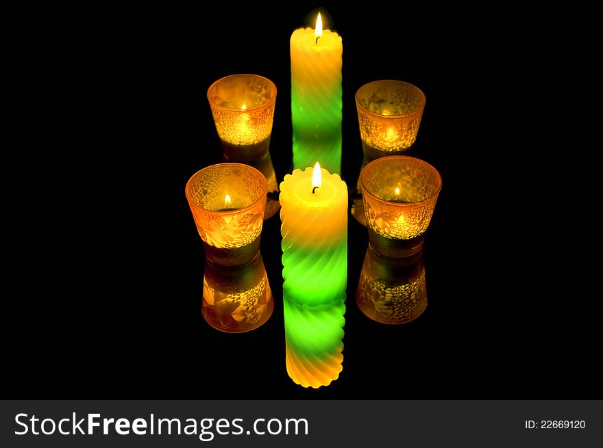 A few burning candles in the dark. mirroring. A few burning candles in the dark. mirroring