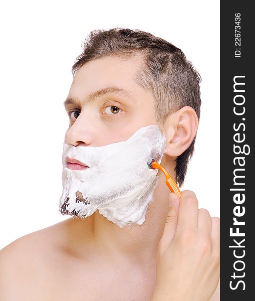 Portrait of a young man shaving. Isolated on white background