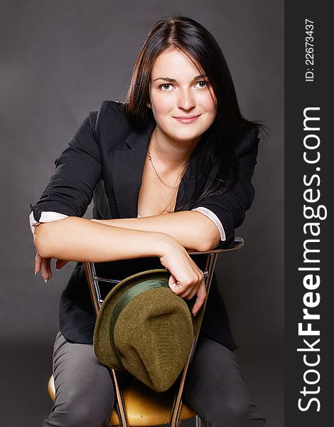 Portrait of smiling young woman sitting on chair. Portrait of smiling young woman sitting on chair