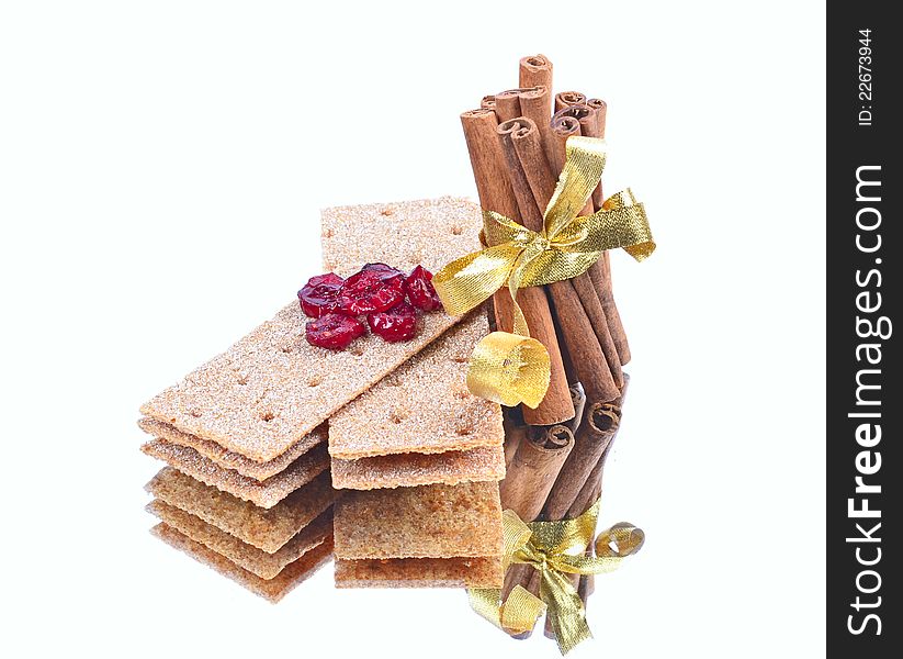 Cinnamon sticks ,stack of crispbread on white background ,reflection, blueberry red,