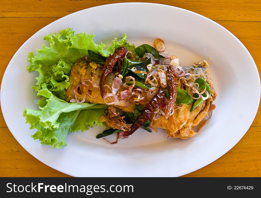 Fried fish with fresh herbs and spicy