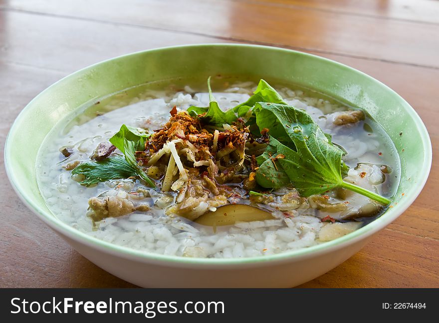 Asian style rice soup with herbs in a bowl. Asian style rice soup with herbs in a bowl
