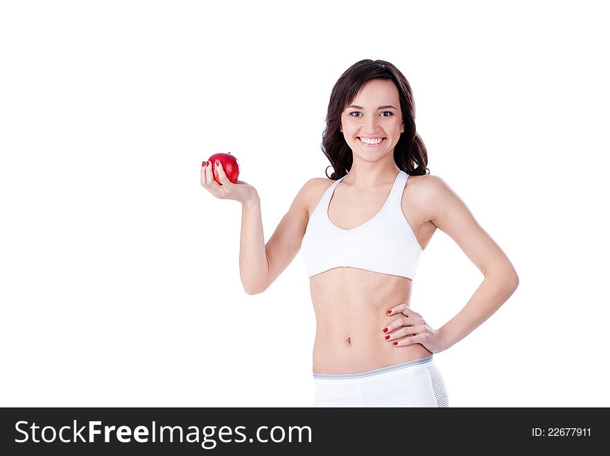 Yound fit girl holding red apple and smiling