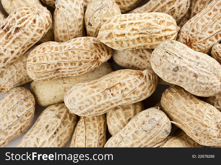 Background of roasted peanuts in shell