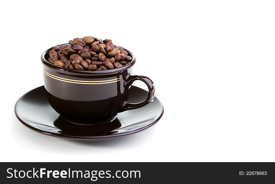 Brown ceramic cup filled with coffee beans. Brown ceramic cup filled with coffee beans