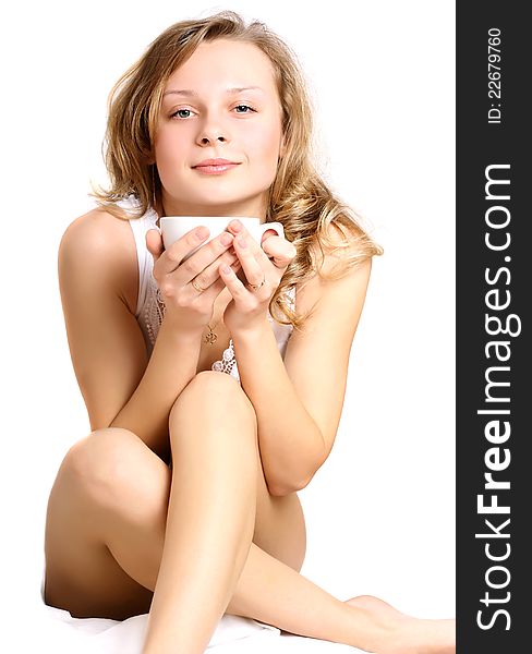 Beautiful young blond young woman with a cup. Beautiful young blond young woman with a cup