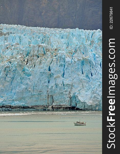 Alaskan Glaciers tower over boat