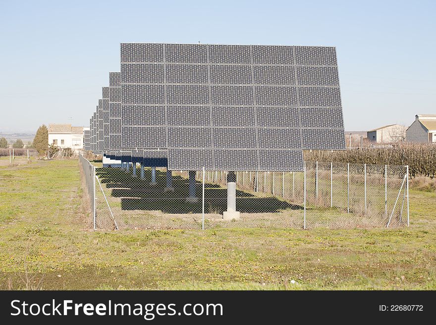 Solar panels placed in a row or orchard