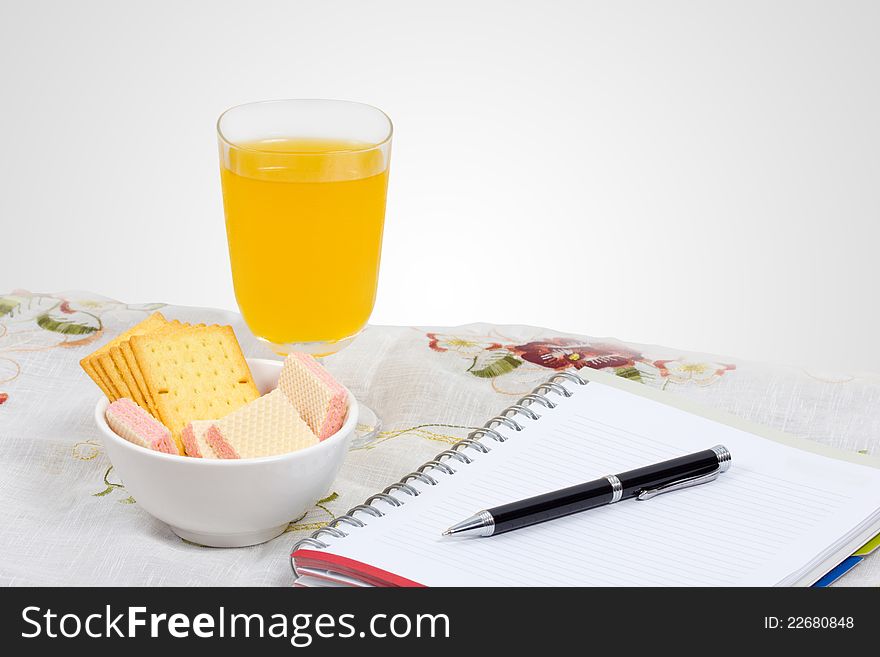 Wafer, cheese crackers and empty note book on a table. Wafer, cheese crackers and empty note book on a table.