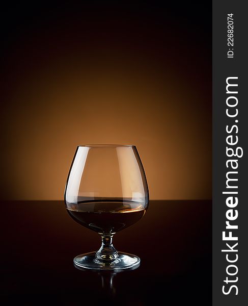 Glass of luxury cognac at bar counter with copy space. Glass of luxury cognac at bar counter with copy space