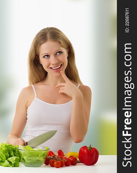 Fun happy young woman preparing vegetarian food, vegetables in the kitchen. Fun happy young woman preparing vegetarian food, vegetables in the kitchen