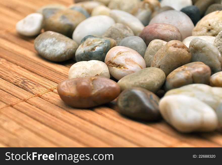 Small polished stones macro over wicker. Small polished stones macro over wicker