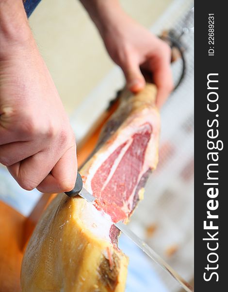 Waiter is slicing jamon at home. Waiter is slicing jamon at home.