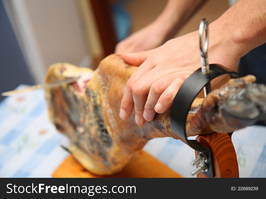 Waiter is slicing jamon at home. Waiter is slicing jamon at home.