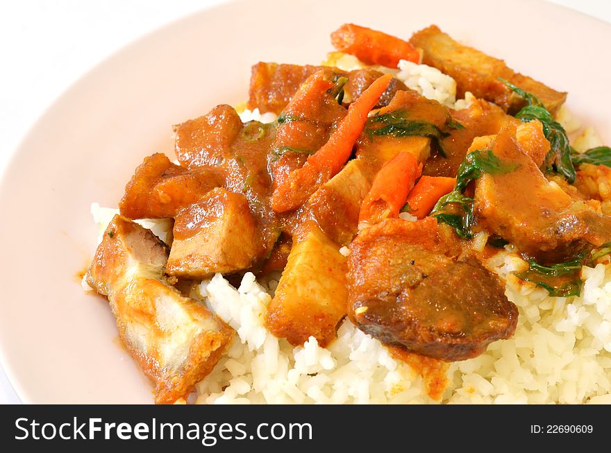 Stir fried crispy pork with red curry paste and rice. Stir fried crispy pork with red curry paste and rice