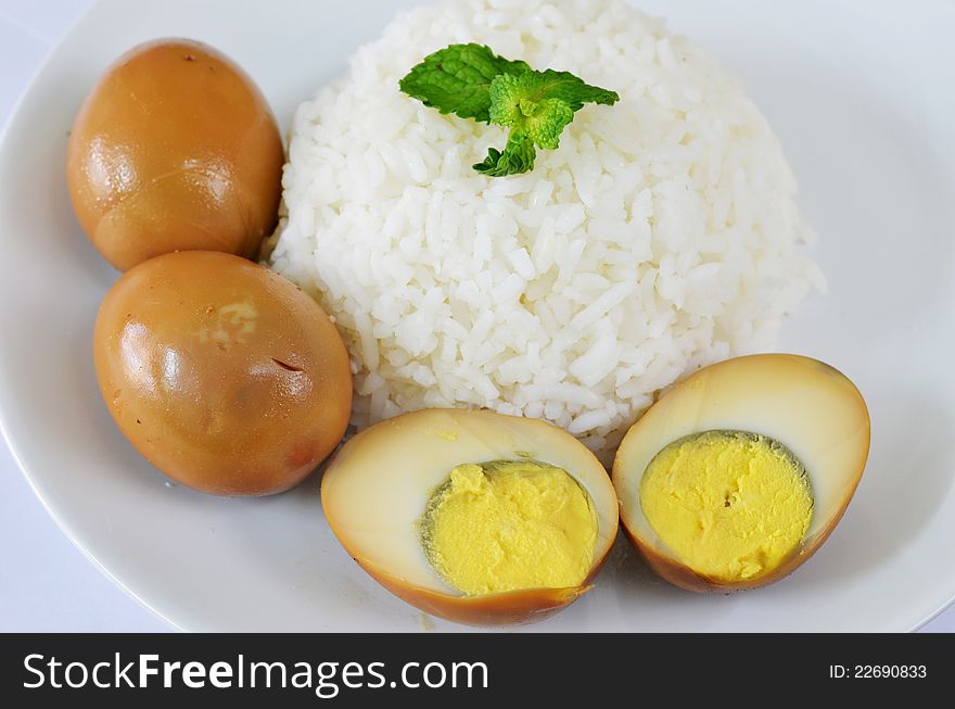 Steamed rice served with eggs in brown sauce. Steamed rice served with eggs in brown sauce