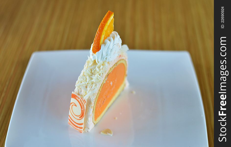 Orange ice cream cake with whipped cream