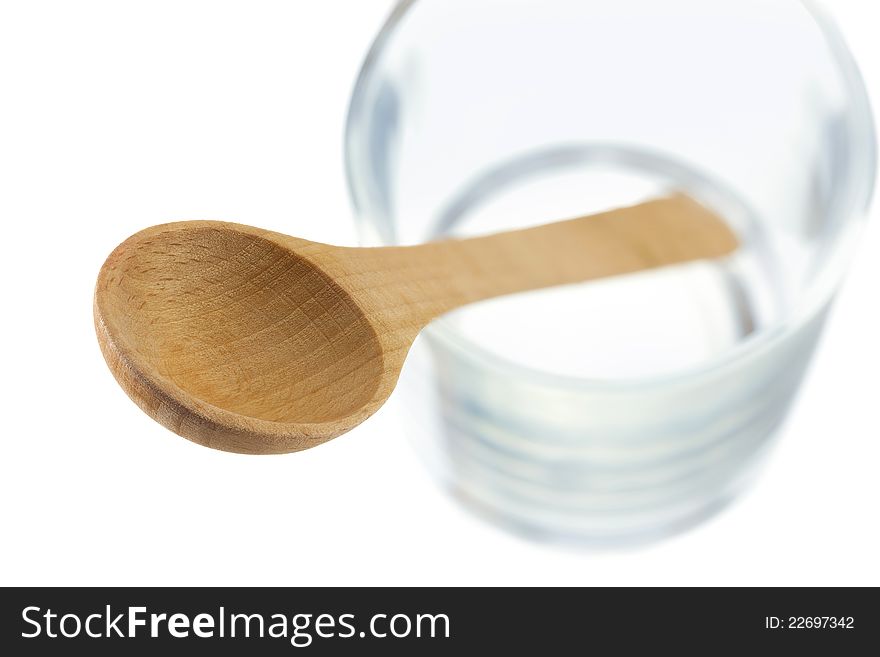 Wooden spoon in a glass isolated on white with clipping path.