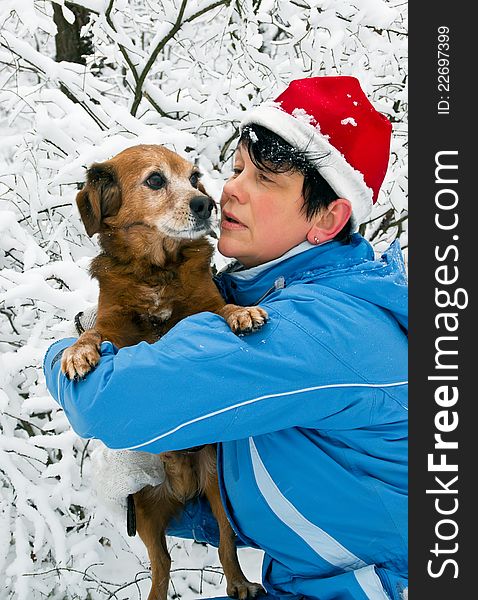 Woman with dog walks in snow wood